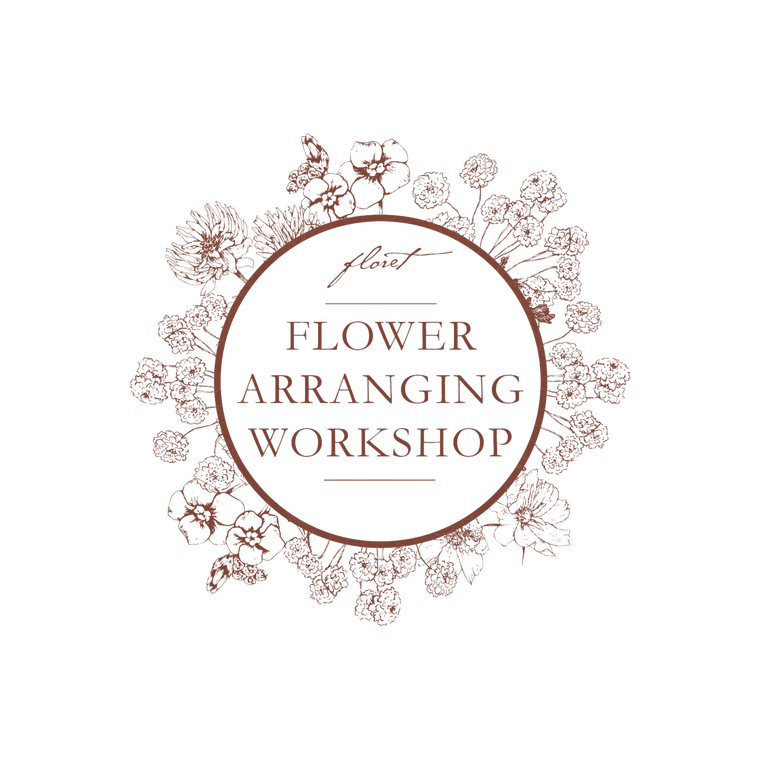 A circular logo for a flower arranging workshop, featuring the words 'Flower Arranging Workshop' in brown serif text inside a brown circle, surrounded by delicate brown floral line drawings on a white background.